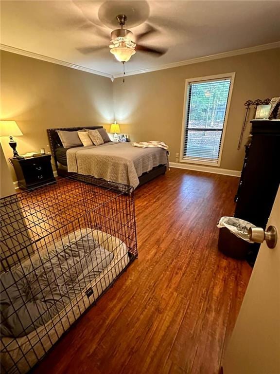 bedroom featuring hardwood / wood-style floors, ceiling fan, and ornamental molding