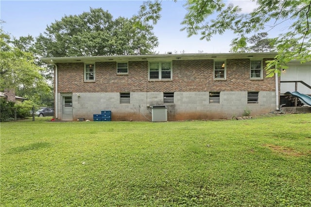 2720 Birchwood Way SW, Marietta, GA 30060 - back of house featuring a lawn, central AC, and brick siding
