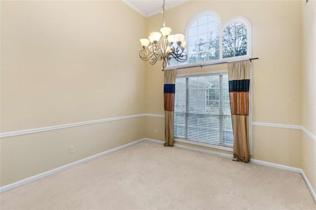carpeted empty room with a chandelier