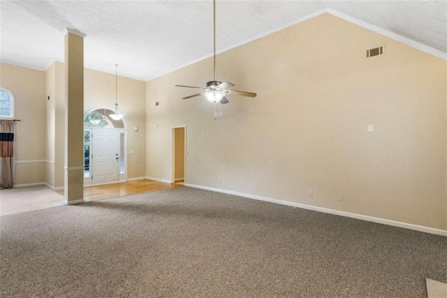 unfurnished room with high vaulted ceiling, carpet flooring, ceiling fan, ornamental molding, and a textured ceiling