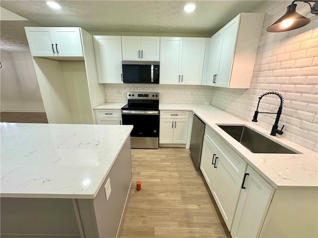 850 Greenhedge Dr, Stone Mountain, GA 30088 - kitchen with appliances with stainless steel finishes, light wood-style flooring, tasteful backsplash, light stone countertops, and recessed lighting