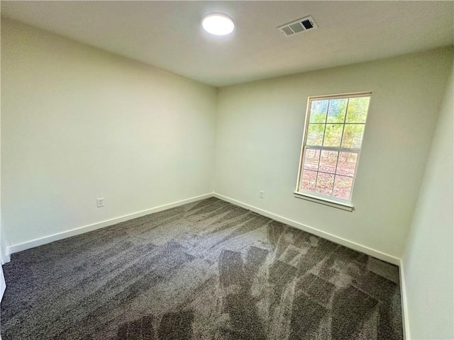850 Greenhedge Dr, Stone Mountain, GA 30088 - spare room with dark carpet and baseboards