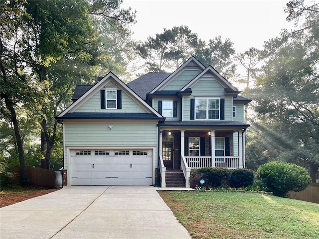 craftsman house with a garage, a porch, and a front lawn