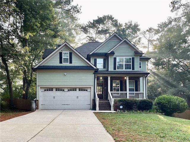 craftsman-style home featuring a garage, a porch, and a front lawn