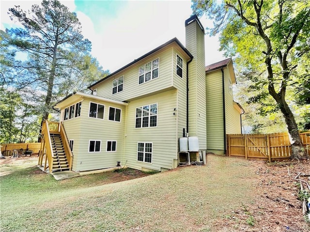 back of property featuring a lawn