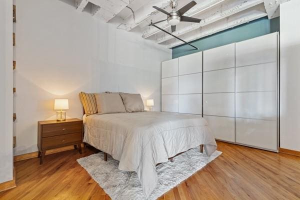 bedroom with light wood-type flooring and ceiling fan