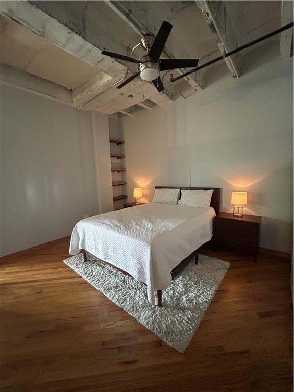 bedroom with ceiling fan and hardwood / wood-style flooring