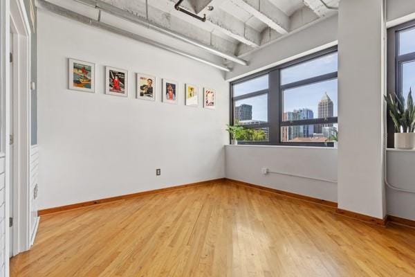 unfurnished room featuring hardwood / wood-style flooring