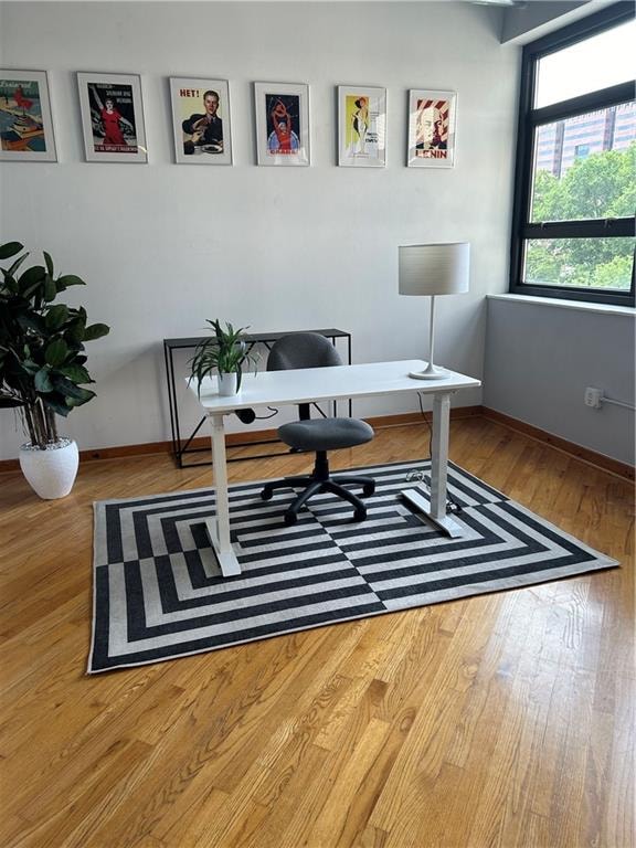 office with light wood-type flooring