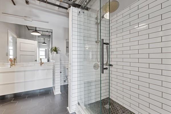 bathroom with tile patterned flooring, vanity, and a shower with shower door