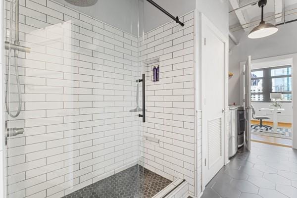 bathroom featuring tile patterned flooring and a shower with shower door