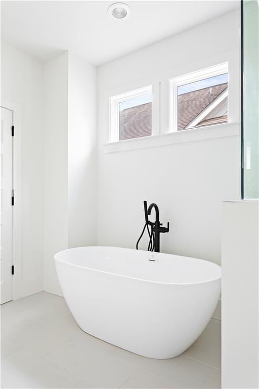 full bath featuring a freestanding bath and tile patterned floors
