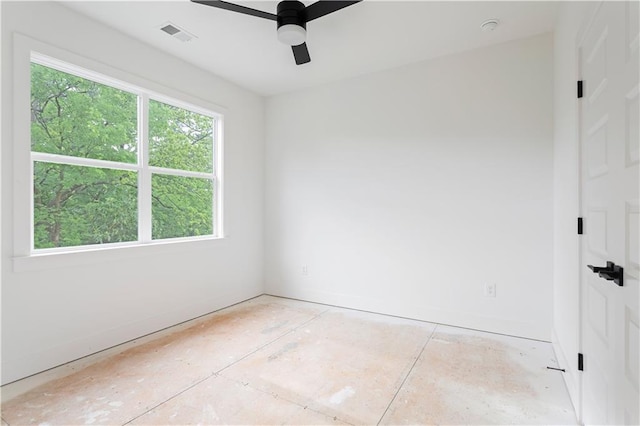 unfurnished room featuring visible vents, a ceiling fan, and baseboards
