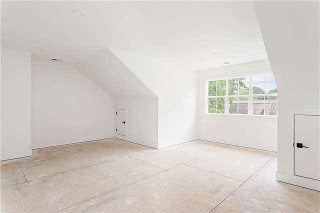 additional living space with visible vents and vaulted ceiling