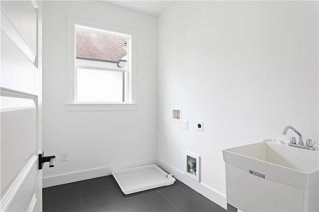 laundry room with washer hookup, hookup for an electric dryer, laundry area, dark tile patterned flooring, and a sink