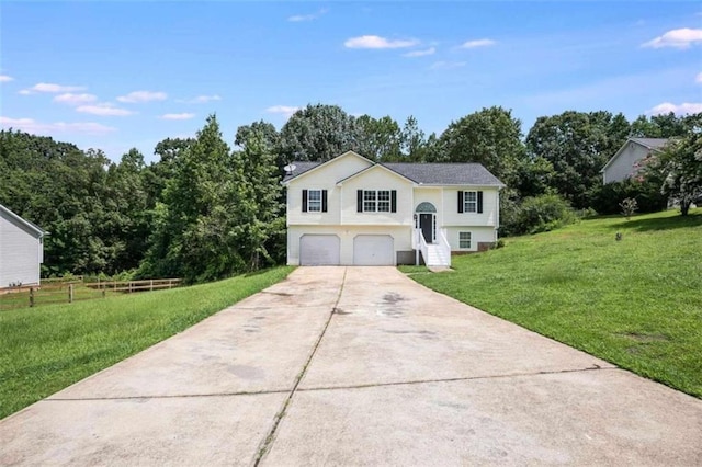 bi-level home with a garage and a front lawn