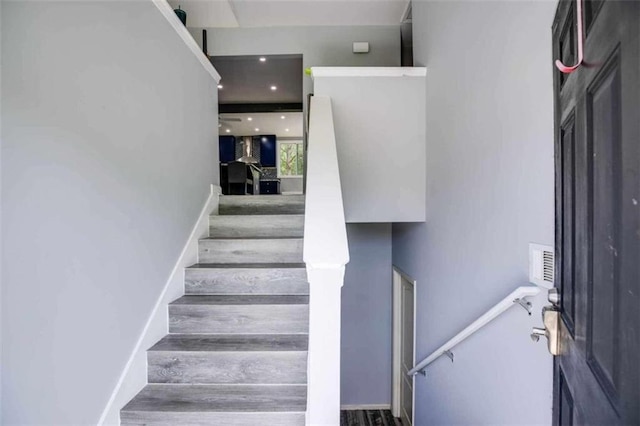 staircase with wood-type flooring