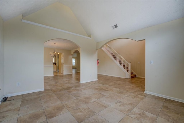 spare room featuring arched walkways, high vaulted ceiling, visible vents, baseboards, and stairway