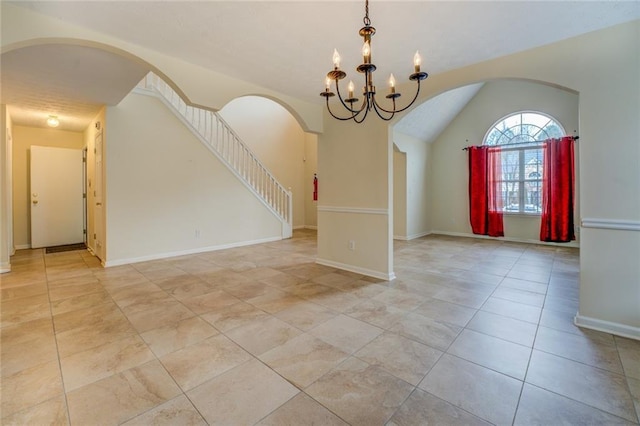 unfurnished room featuring lofted ceiling, light tile patterned floors, baseboards, and a chandelier