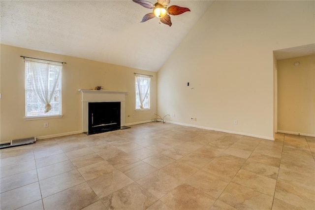 unfurnished living room featuring a fireplace, light tile patterned floors, a ceiling fan, high vaulted ceiling, and baseboards