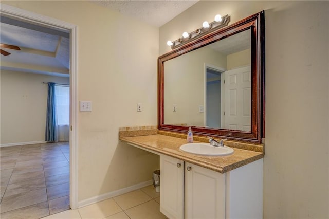 bathroom featuring baseboards, ceiling fan, tile patterned flooring, a textured ceiling, and vanity