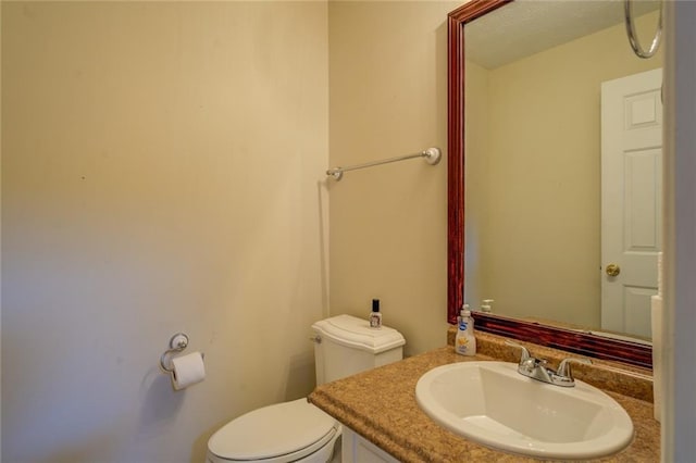 half bathroom with toilet and vanity