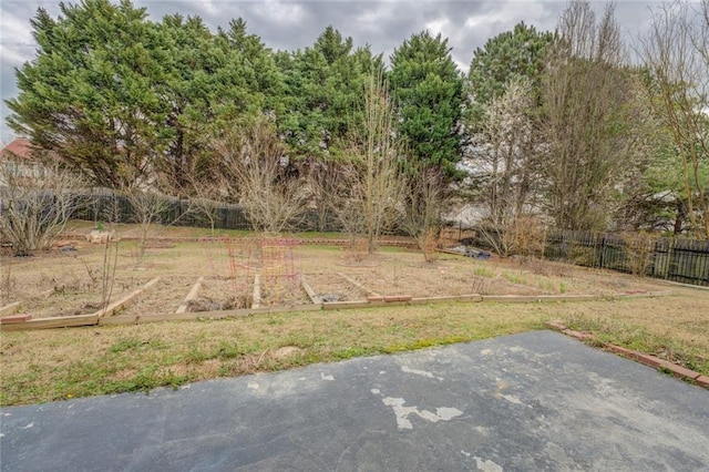 view of yard with a patio area, a fenced backyard, and a garden