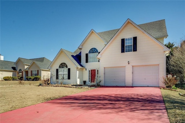 traditional home with an attached garage and concrete driveway