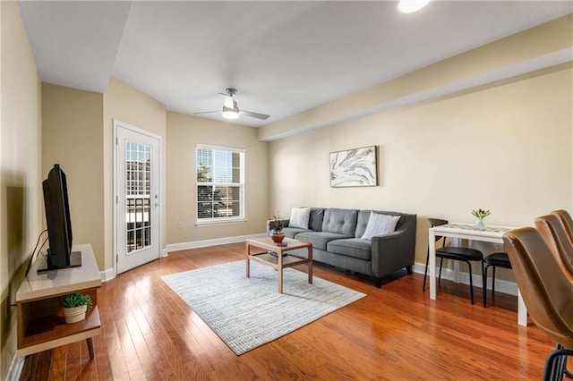 living room featuring ceiling fan and wood-type flooring