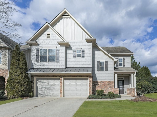 craftsman house featuring a garage and a front yard