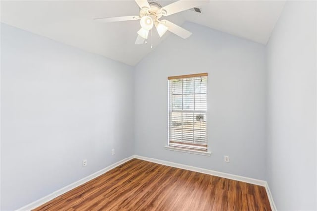 spare room with ceiling fan, lofted ceiling, baseboards, and wood finished floors