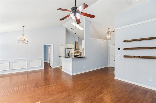 unfurnished living room featuring dark wood finished floors, baseboards, ceiling fan with notable chandelier, and high vaulted ceiling