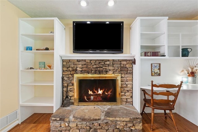 86 Sleepy Hollow Rd, Dahlonega, GA 30533 - living room with wood finished floors, a fireplace, and a textured ceiling