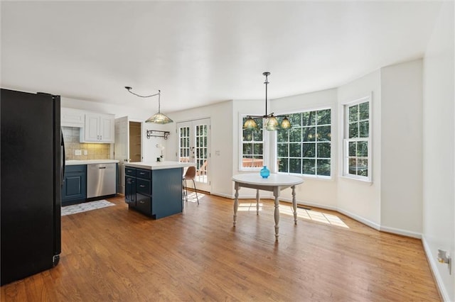 86 Sleepy Hollow Rd, Dahlonega, GA 30533 - kitchen featuring freestanding refrigerator, dishwasher, plenty of natural light, and light countertops