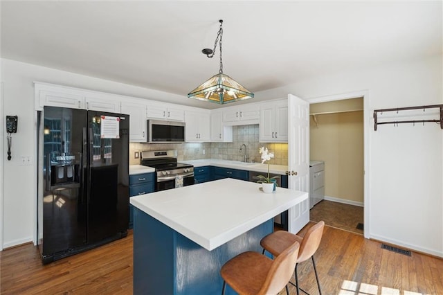 86 Sleepy Hollow Rd, Dahlonega, GA 30533 - kitchen featuring stainless steel appliances, dark wood-style flooring, tasteful backsplash, washer / dryer, and a breakfast bar area