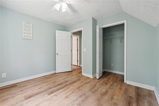 86 Sleepy Hollow Rd, Dahlonega, GA 30533 - unfurnished bedroom with light wood-style floors, a closet, vaulted ceiling, ceiling fan, and a textured ceiling