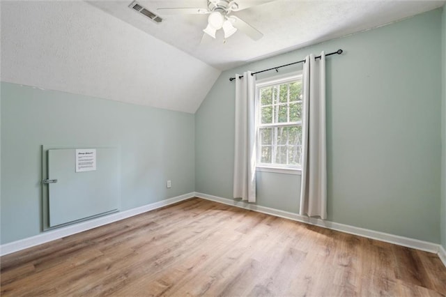 86 Sleepy Hollow Rd, Dahlonega, GA 30533 - additional living space featuring light wood-style floors, vaulted ceiling, ceiling fan, and a textured ceiling