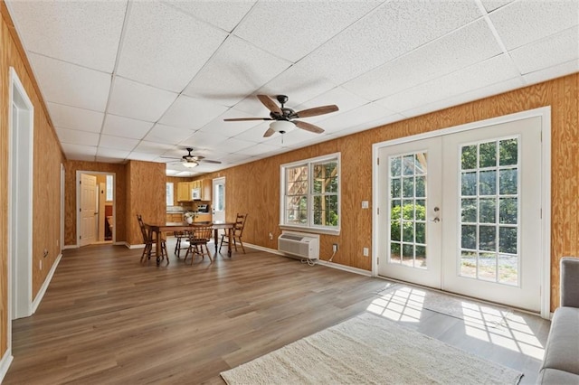 86 Sleepy Hollow Rd, Dahlonega, GA 30533 - unfurnished dining area featuring a wall mounted air conditioner, a drop ceiling, french doors, a ceiling fan, and wood finished floors