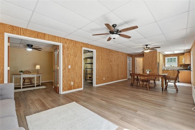 86 Sleepy Hollow Rd, Dahlonega, GA 30533 - living room with a paneled ceiling, ceiling fan, light wood finished floors, and wood walls