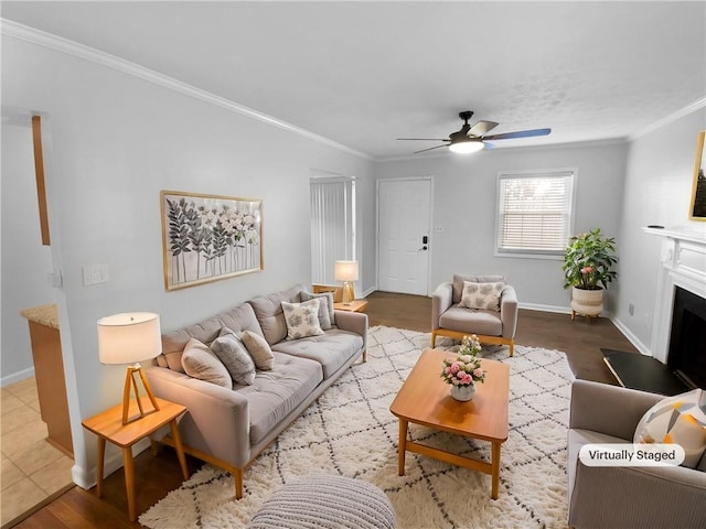 living room featuring ceiling fan, wood-type flooring, and crown molding