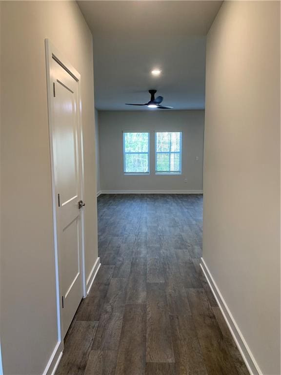 hallway with dark hardwood / wood-style flooring