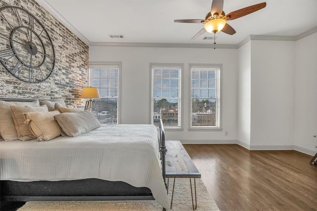 bedroom with multiple windows, crown molding, dark hardwood / wood-style floors, and ceiling fan