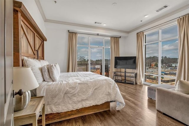 bedroom with crown molding, access to exterior, and hardwood / wood-style floors