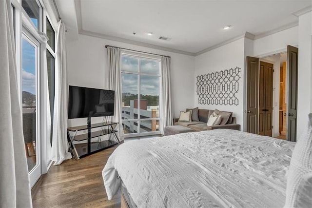 bedroom featuring ornamental molding, access to exterior, and dark hardwood / wood-style flooring