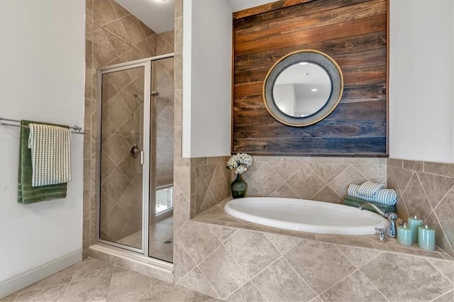 bathroom featuring tile patterned floors and separate shower and tub