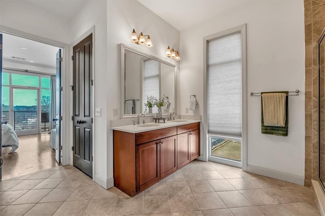 bathroom featuring vanity, tile patterned flooring, and a shower with door