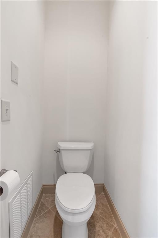 bathroom featuring tile patterned floors and toilet