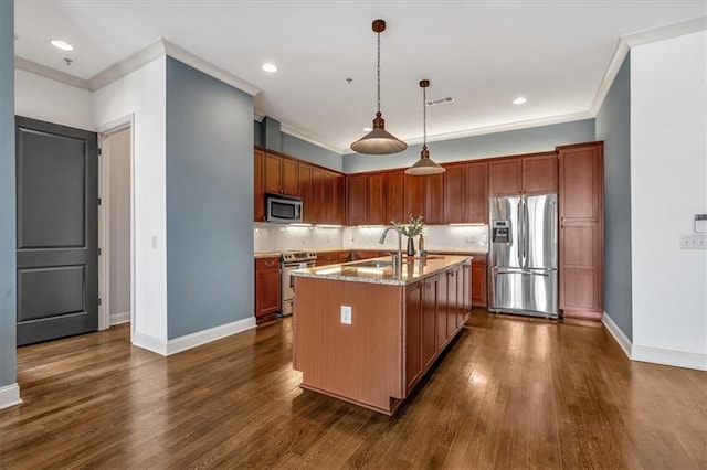 kitchen with a kitchen island with sink, hanging light fixtures, stainless steel appliances, light stone counters, and dark hardwood / wood-style flooring