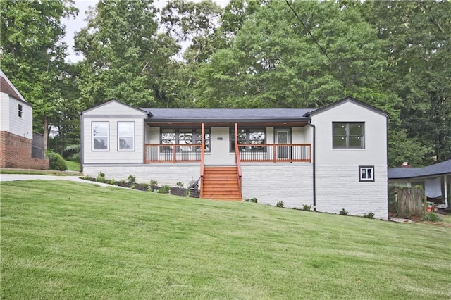 view of front of home with a front yard and covered porch