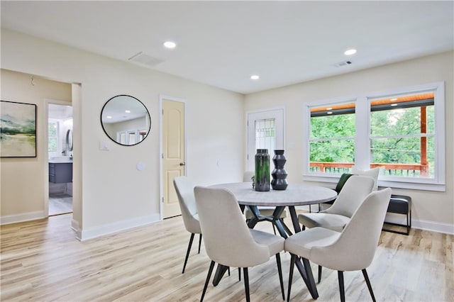 dining space featuring light wood-type flooring